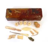 An oriental lacquered glove box and contents of various ivory and bone sewing items, mother of pearl