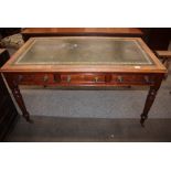 A Victorian mahogany writing table, leather inset top above three drawers, fitted brass pulls,