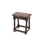An Antique oak joint stool, having rectangular moulded top, raised on turned supports united by