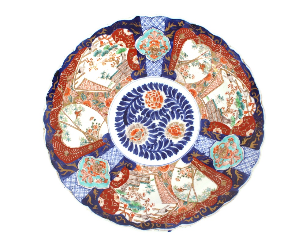 A pair of 19th Century Japanese Imari chargers, having scallop borders, panels decorated with