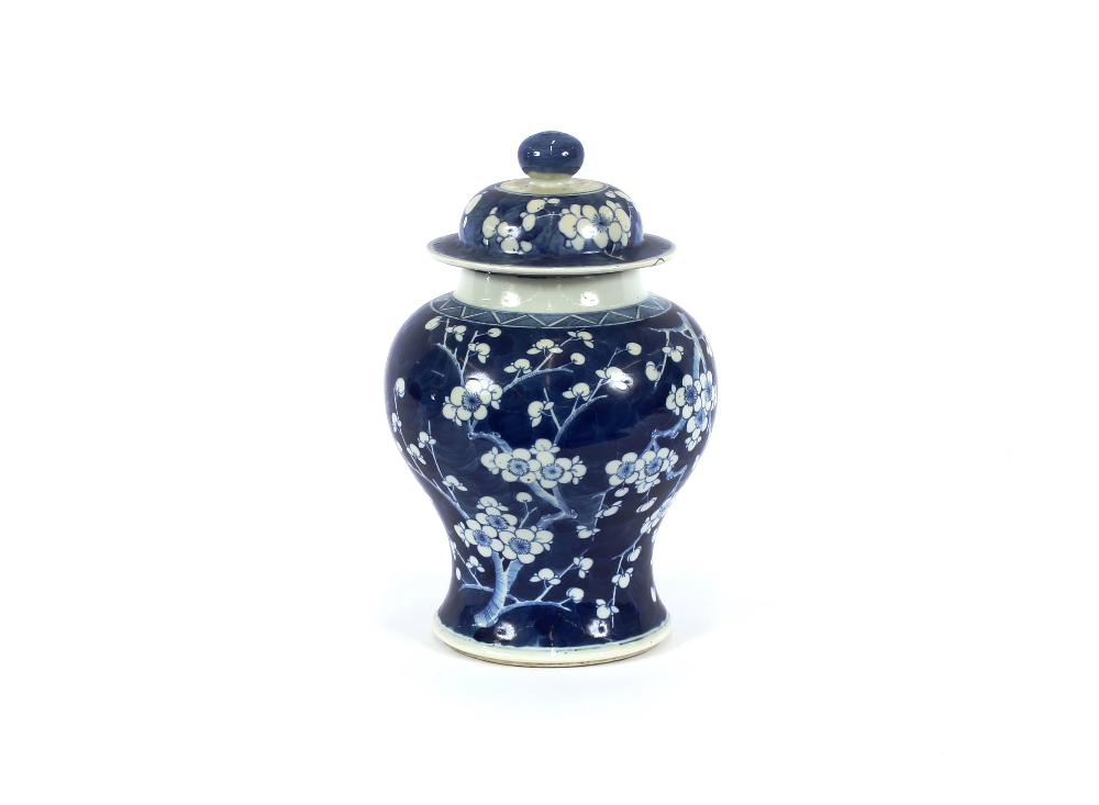 A 19th Century Chinese blue and white baluster vase and cover, with Hawthorn decoration, six