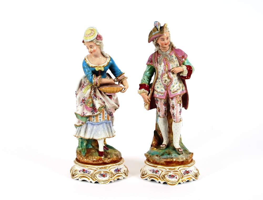 A pair of late 19th Century Meissen style figures, depicting maid and youth, raised on floral