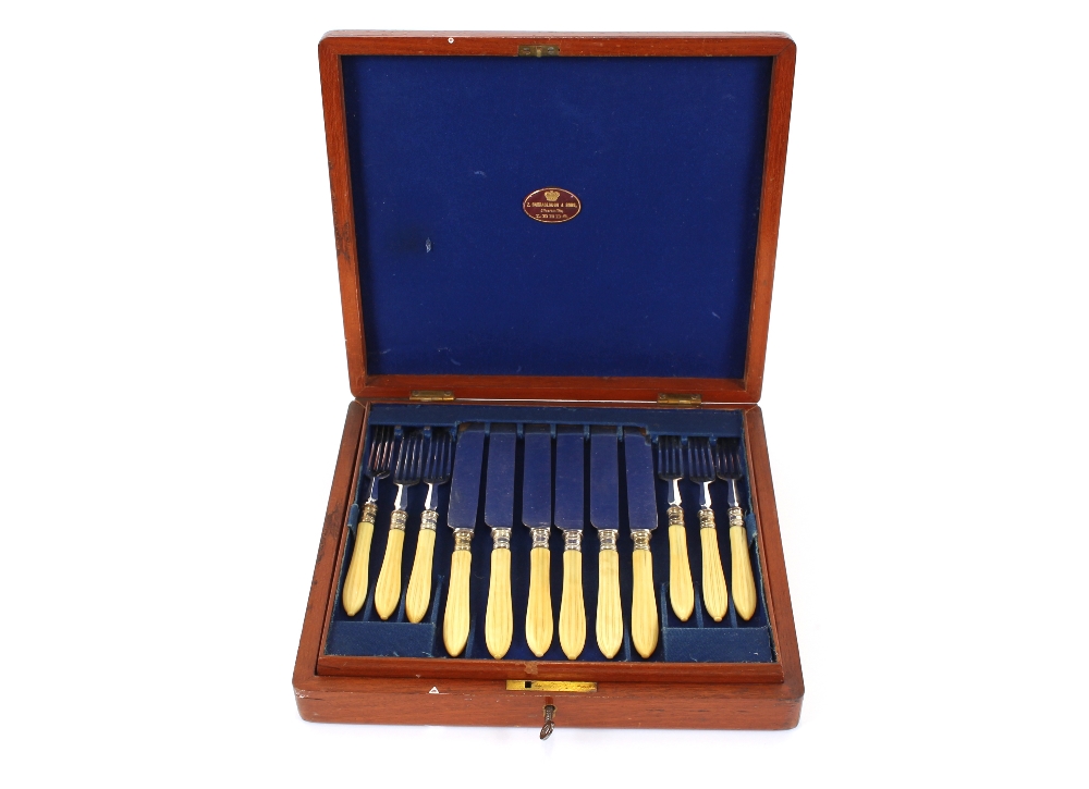 A mahogany cased set of 12 each ivory handled fruit knives and forks