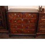 An 18th Century walnut chest in two sections, fitted two short and three long drawers with brass