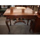 An 18th Century Irish walnut side table,the overhanging top above a shaped frieze raised on cabriole