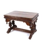 A late Victorian Gothic carved oak side table, fitted with a single drawer above lion masks and