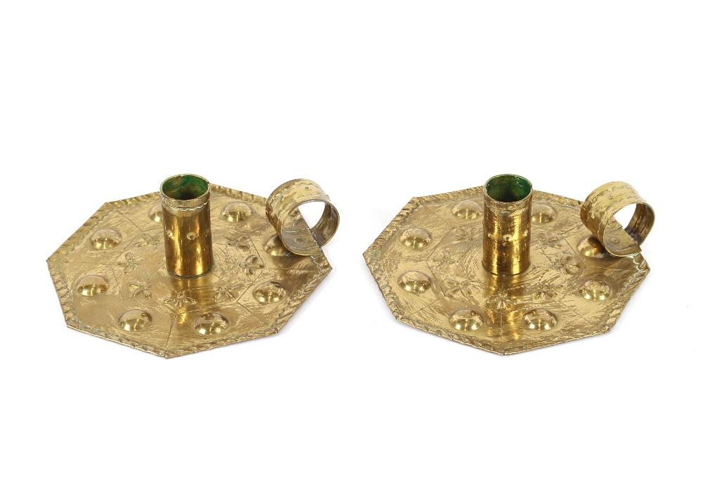 A pair of brass Arts & Crafts design chamber sticks