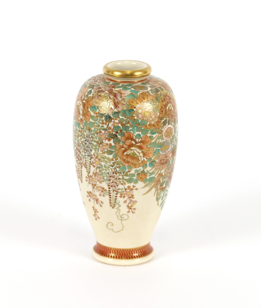 A Japanese Satsuma baluster vase, having profuse floral decoration heightened in gilt, signature