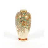 A Japanese Satsuma baluster vase, having profuse floral decoration heightened in gilt, signature