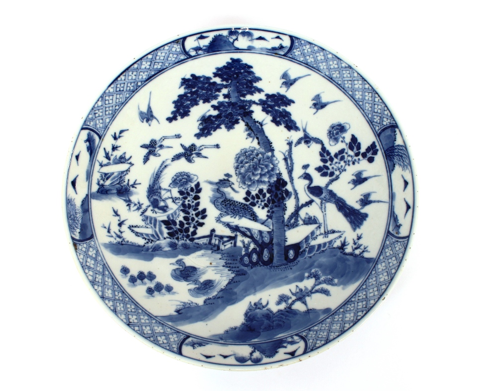 An 18th Century Chinese blue and white plate, the body profusely decorated with exotic birds and