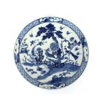 An 18th Century Chinese blue and white plate, the body profusely decorated with exotic birds and