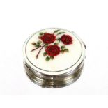 A vintage silver and enamelled ladies compact, decorated with red roses