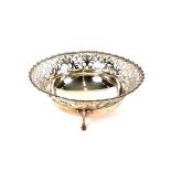 A George V pierced silver bowl, Sheffield 1910, raised on three pad feet, 21cm dia., approx.