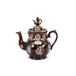 A 19th Century Bargeware teapot, decorated in the traditional manner with clusters of posies on