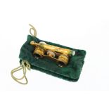 A pair of enamelled opera glasses, in a pouch