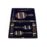 A cased ebony and silver mounted dressing table set