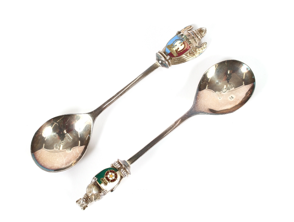 Two silver spoons, decorated with enamelled heraldic crests