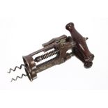 A Vintage corkscrew, with turned wooden handle and crank mechanism; four old fossils to include