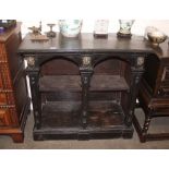 An Antique dark stained oak console table, in the manner of William Kent, decorated lion masks
