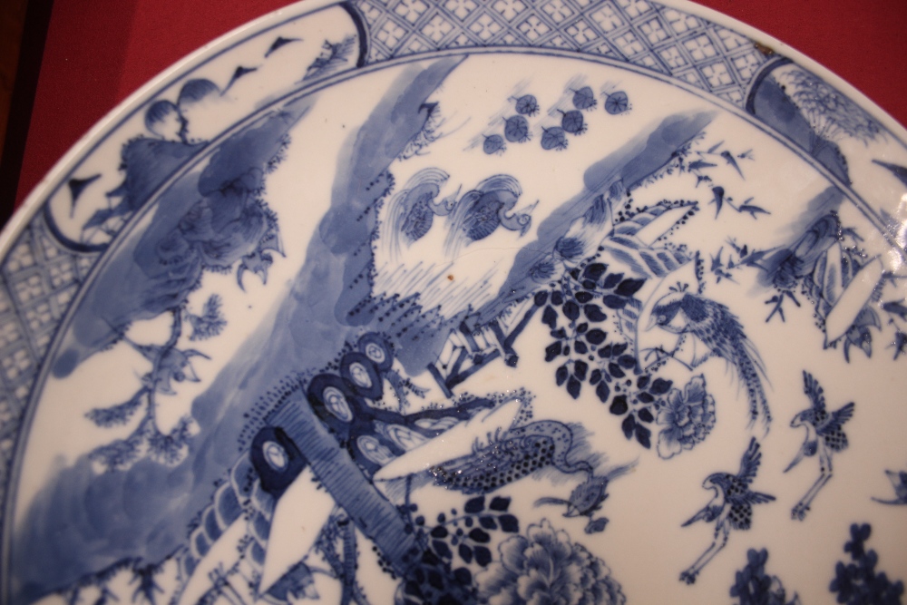 An 18th Century Chinese blue and white plate, the body profusely decorated with exotic birds and - Image 5 of 8