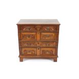 An 18th Century oak geometric moulded panelled chest, fitted two short and three long drawers,