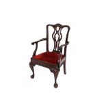 A set of eight carved mahogany Chippendale design dining chairs, having arched cresting rails,