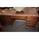 An early 20th Century oak pedestal writing desk, with leather inset top, gadroon border above