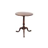 A Georgian mahogany circular snap top occasional table, raised on a baluster turned column and