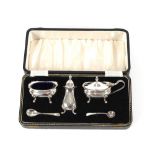 A silver three piece cruet, Birmingham 1987; with associated spoons, cased