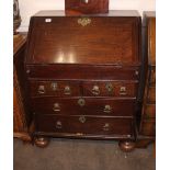 A Georgian oak bureau, of small proportions, having a stepped interior arrangement of drawers and