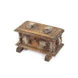 A continental trinket box, in the form of a miniature Cassone with carved head decoration, 21cm