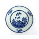 A Chinese blue and white plate, press moulded floral sprays to the flange, centre panel painted with