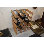 A wine rack and contents containing two bottles o