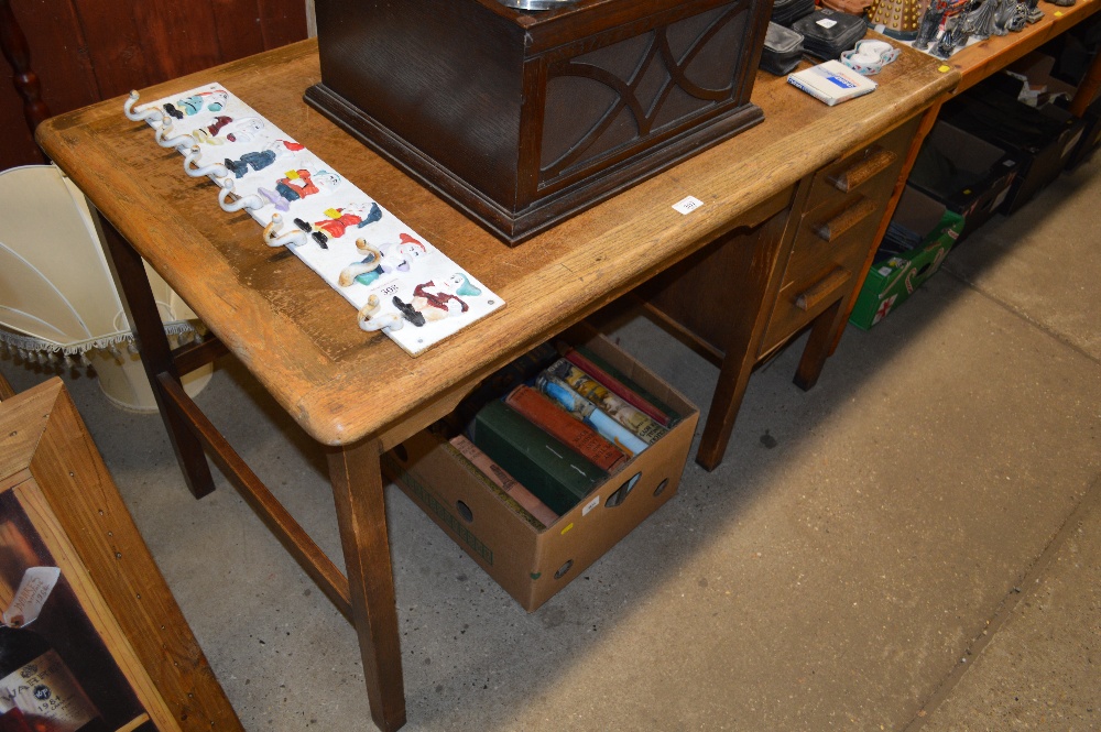 An oak desk fitted three drawers