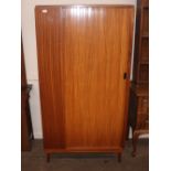 An Austin suite, tambour door wardrobe raised on s