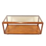 A teak two tier oblong coffee table, with smoked g