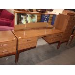 A teak effect dressing table, fitted triple mirror