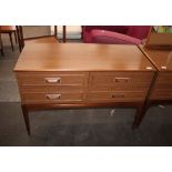 A teak effect dressing table, fitted four drawers,