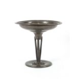 A spot hammered pewter Tazza, raised on triform st