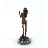 A bronzed figure of a young girl, with hairdryer r