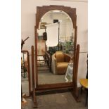 A large oak Art Deco cheval mirror, with arched be