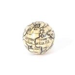 A faux bone globe compass