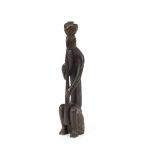 A carved wooden Tribal Art statue, depicting a sea