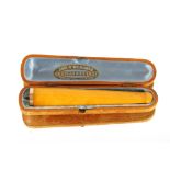 An Amber and gold mounted cheroot holder, containe