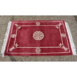An oriental red rug, 6ft x 4ft