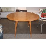 A light Ercol style drop leaf kitchen table, raise