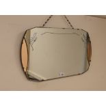 An Art Deco bevel edged frameless wall mirror, wit