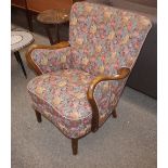 A mid-20th Century continental beech framed easy chair, upholstered