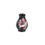 A small Moorcroft baluster vase, decorated flower