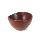 A circular teak fruit bowl